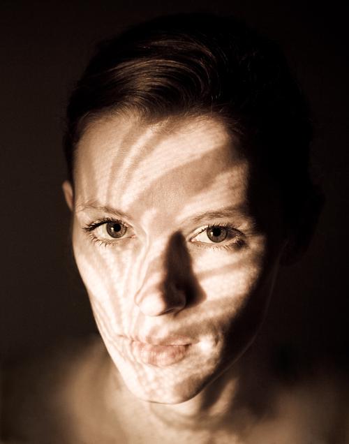 Portrait of woman with lace shadows on her face