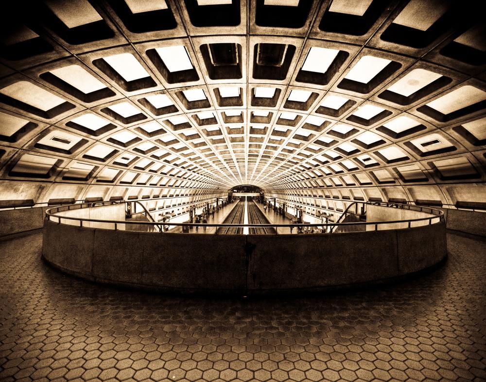 Wide view of Washington DC metro station with an emphasis on the leading lines of the ceiling